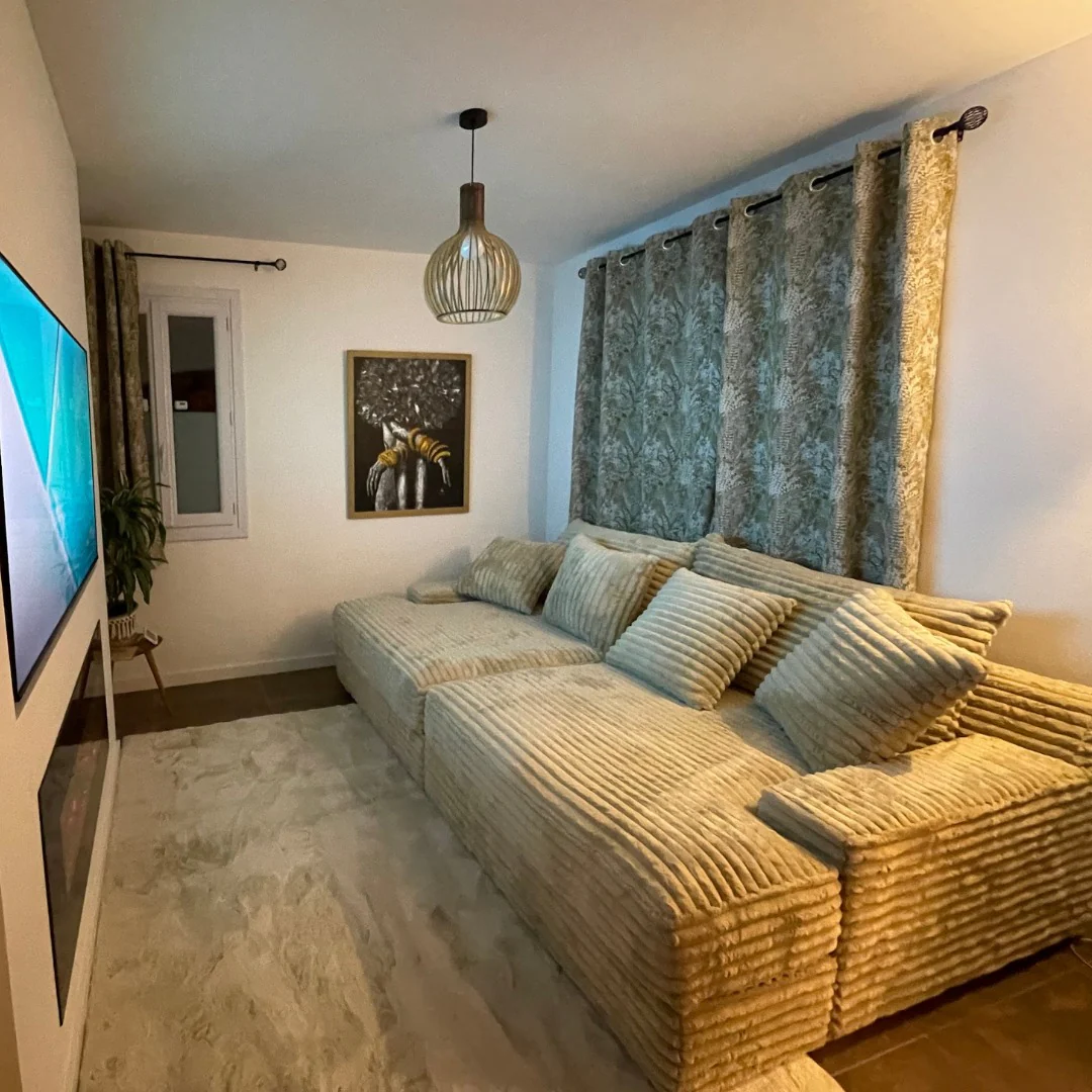 Large L-shaped sofa by Magnus Dream UK in cosy lounge